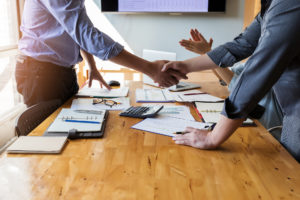 business solutions hand shake in a board meeting